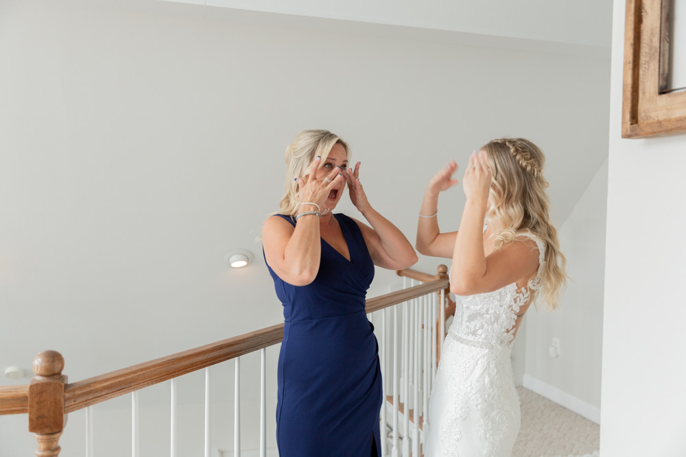Emotional mother daughter moment | Navy blue mother-of-the-bride dress