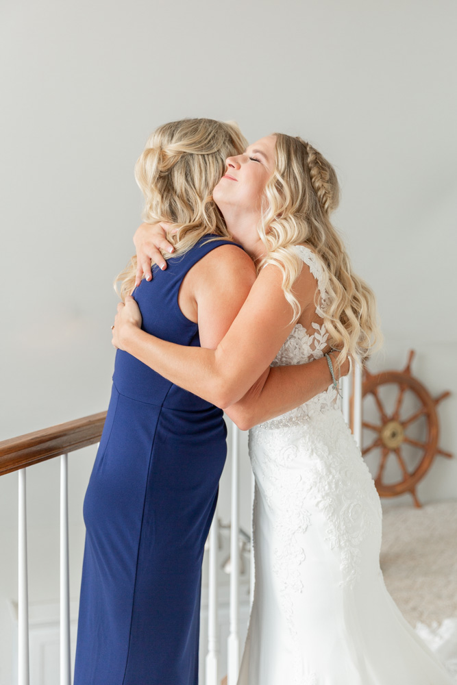 Bride hugs mom wedding day