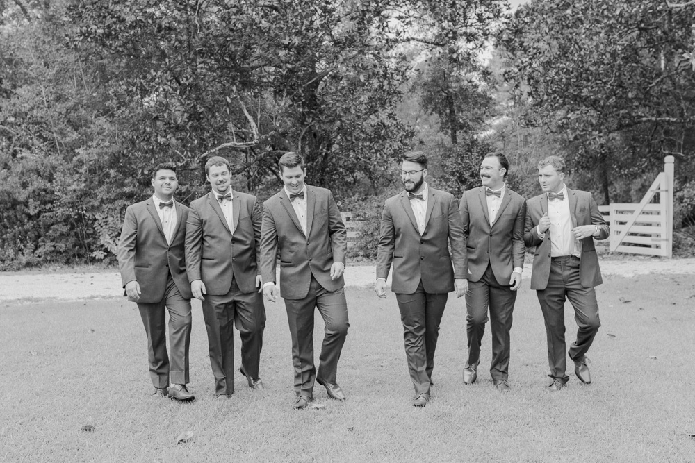 Black and white groomsmen walking 
