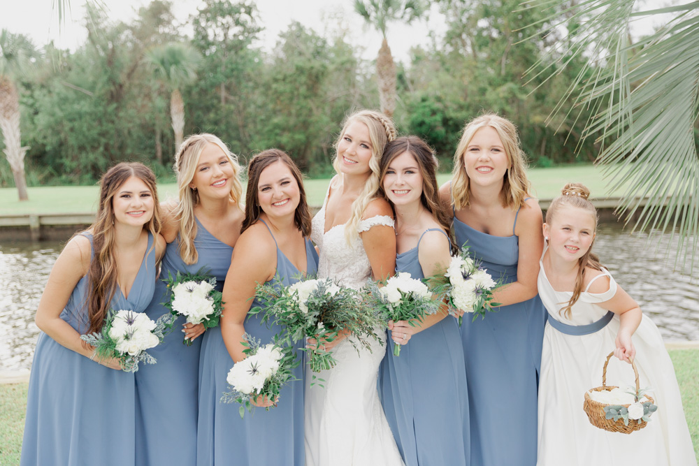 Annie Elise Photography | Dusty Blue bridesmaid portrait by lake | blonde bride