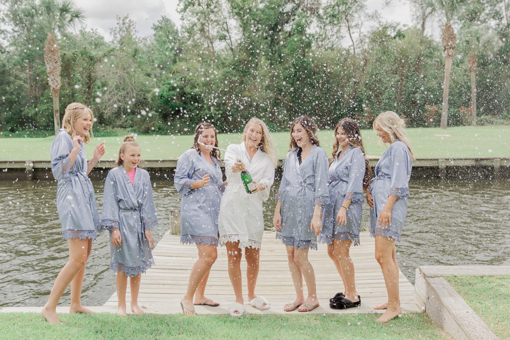 champagne pop | Bridesmaids in robes | light blue